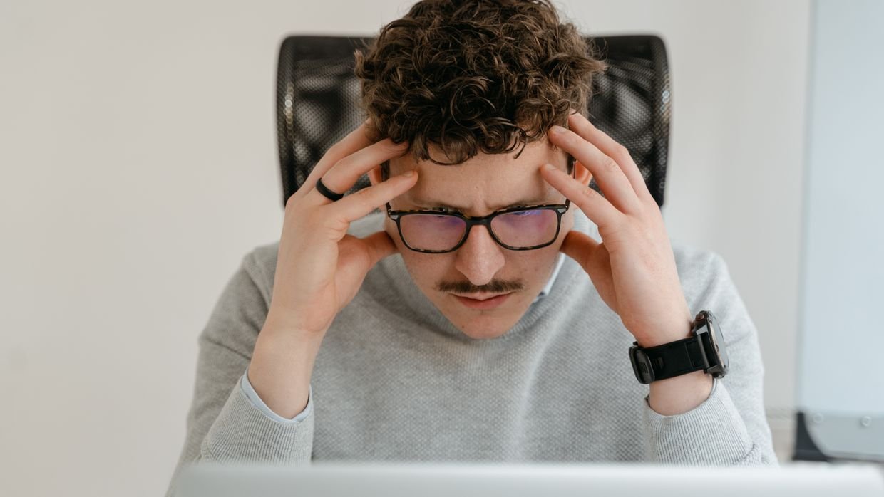 A viewer looking at a laptop, working out why a video has no transcript.