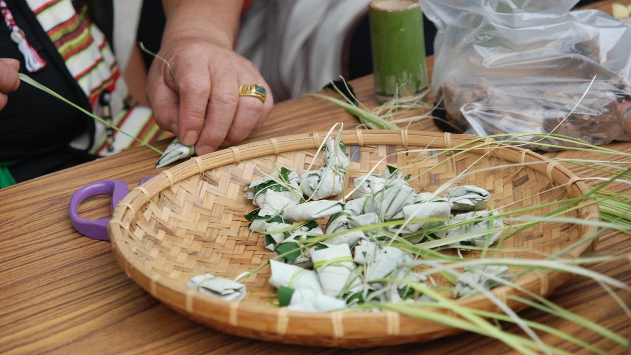 Hands demonstrating a craft technique.