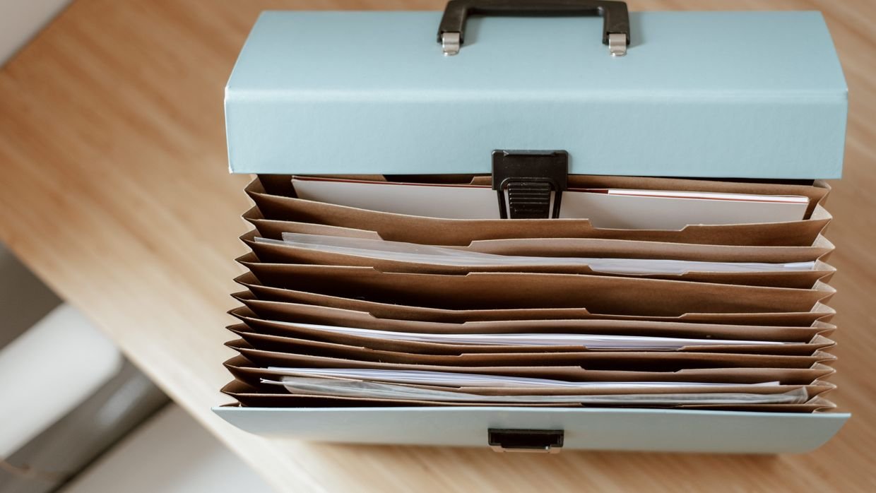 An open folder of documents on a desk.