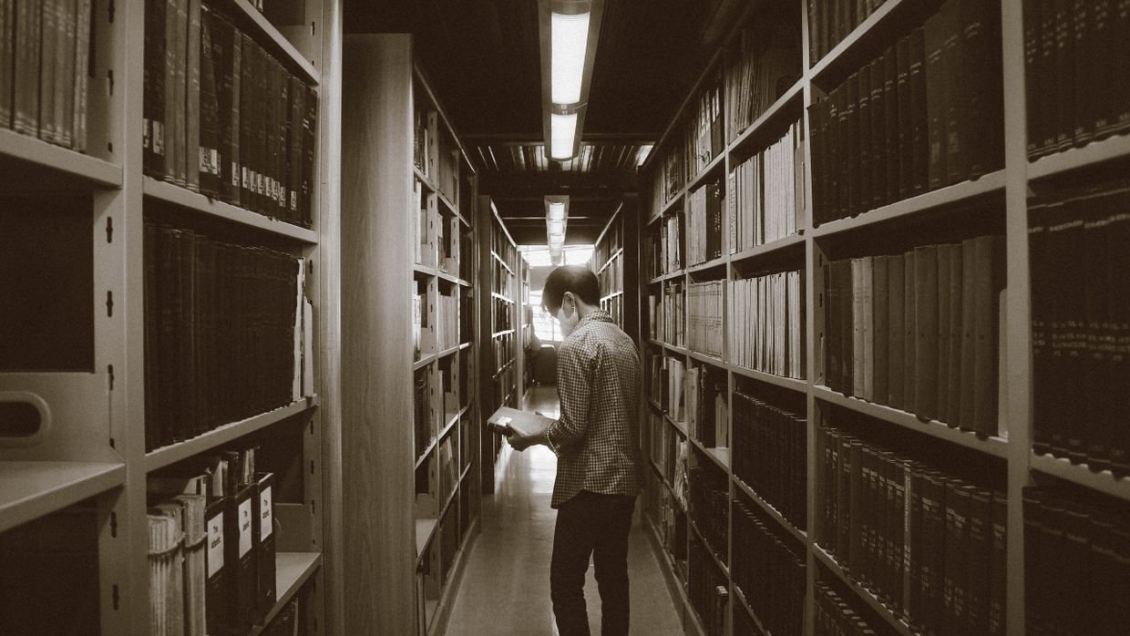 A long corridor lined with library shelving.