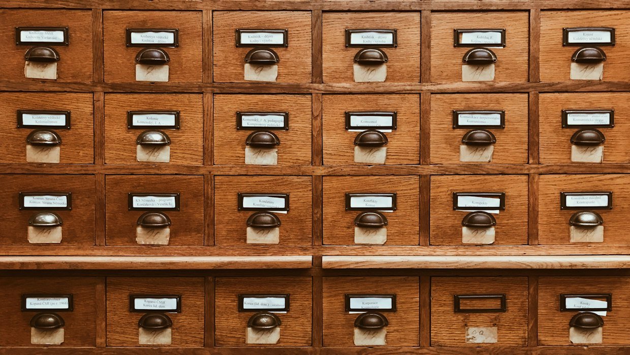 A row of wooden filing drawers.