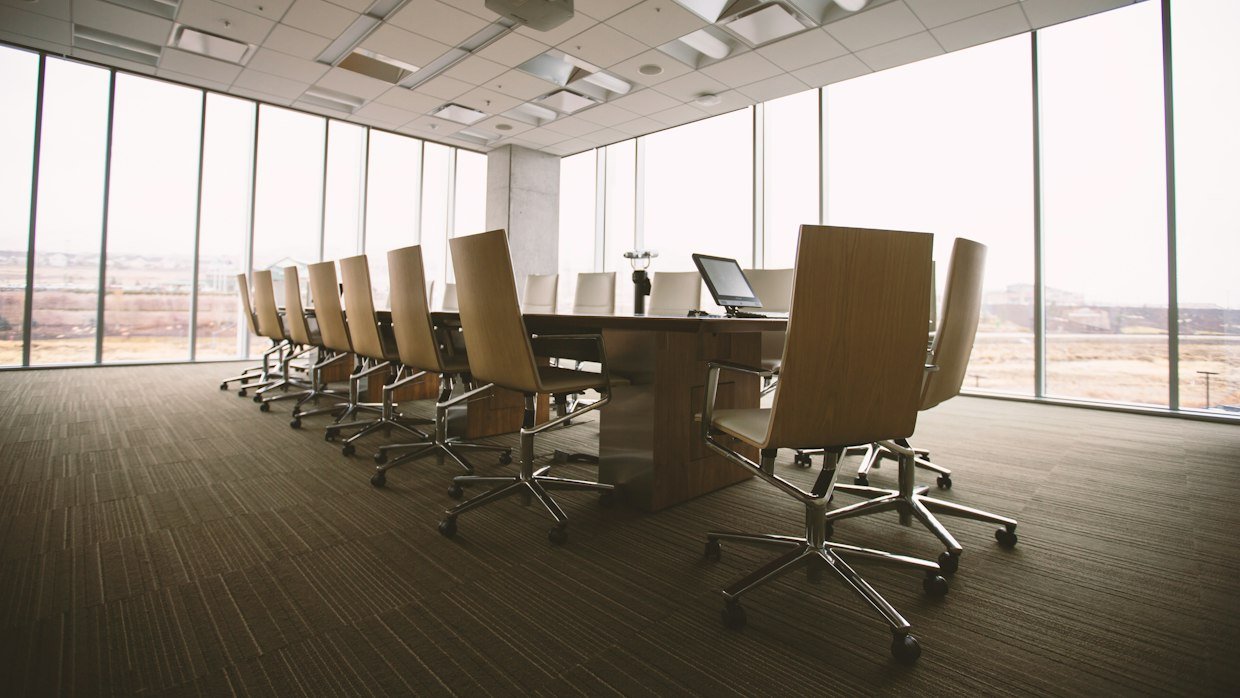 An empty conference room with a projector screen.