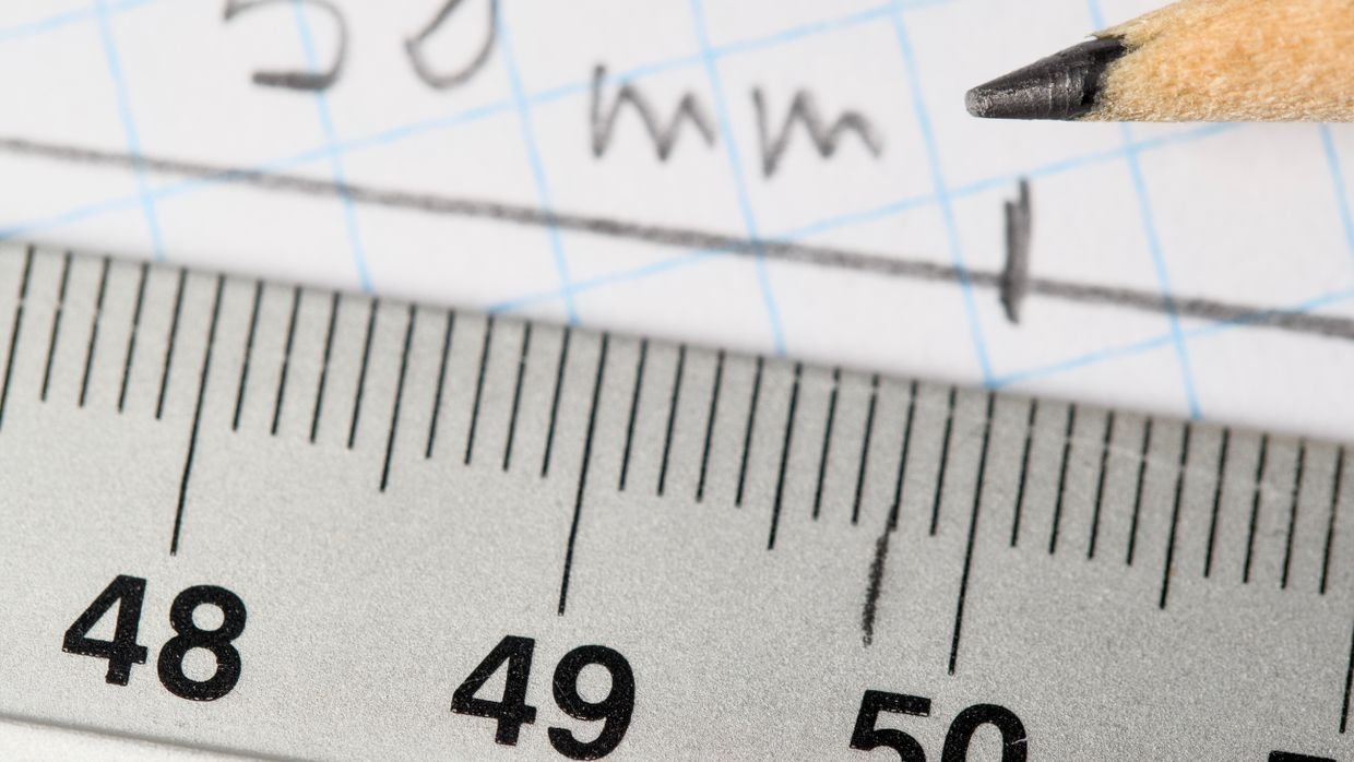 A ruler laid across marked paper.