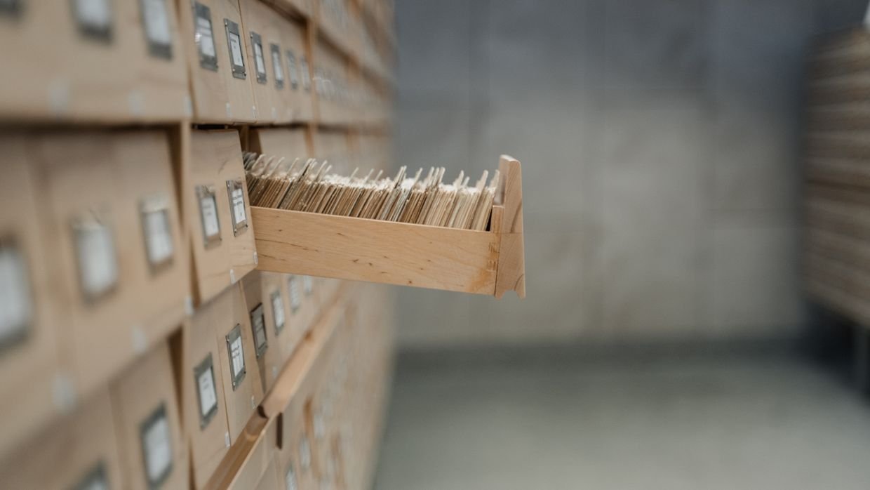 An open card index drawer.