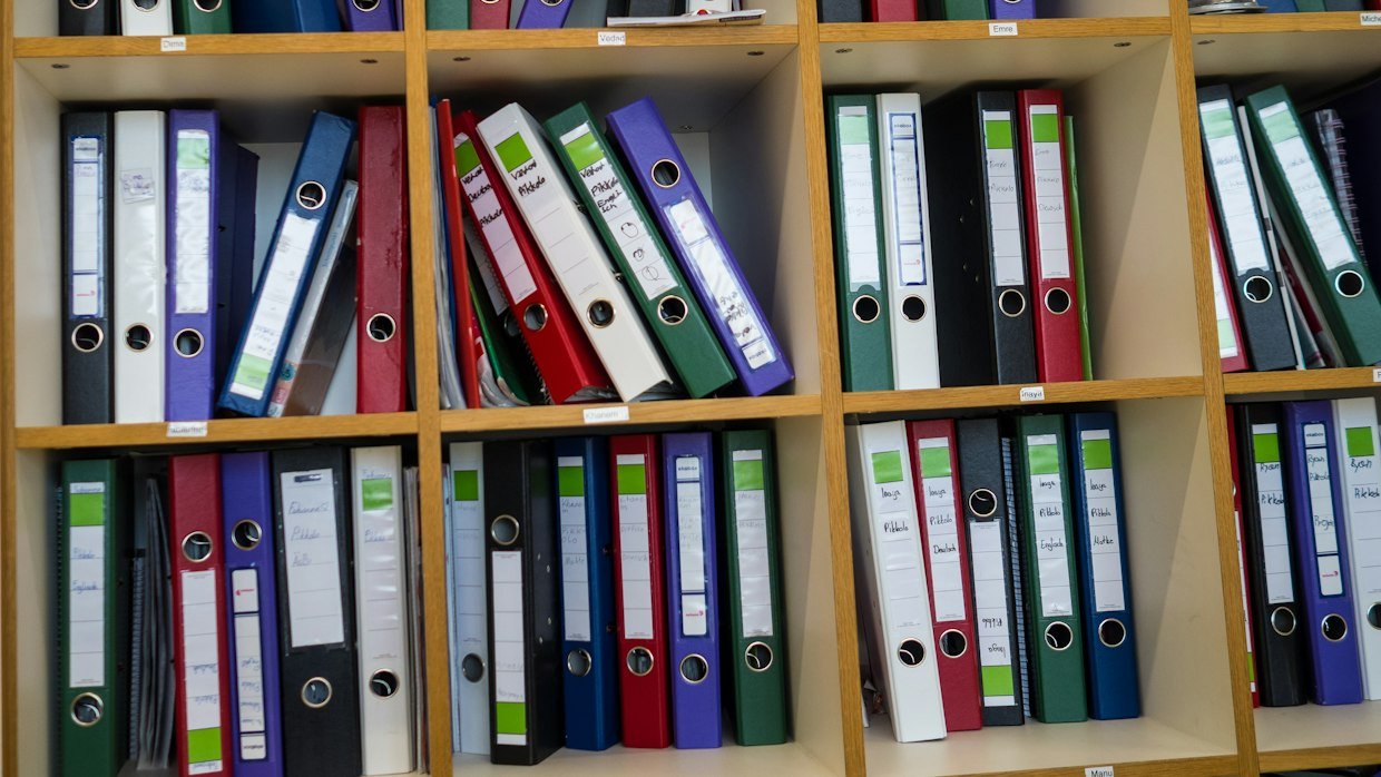 Numbered folders lined up on a shelf.