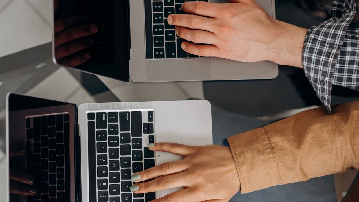 A person at a laptop weighing options, for comparing Opera AI, a chatbot and a summarizer.