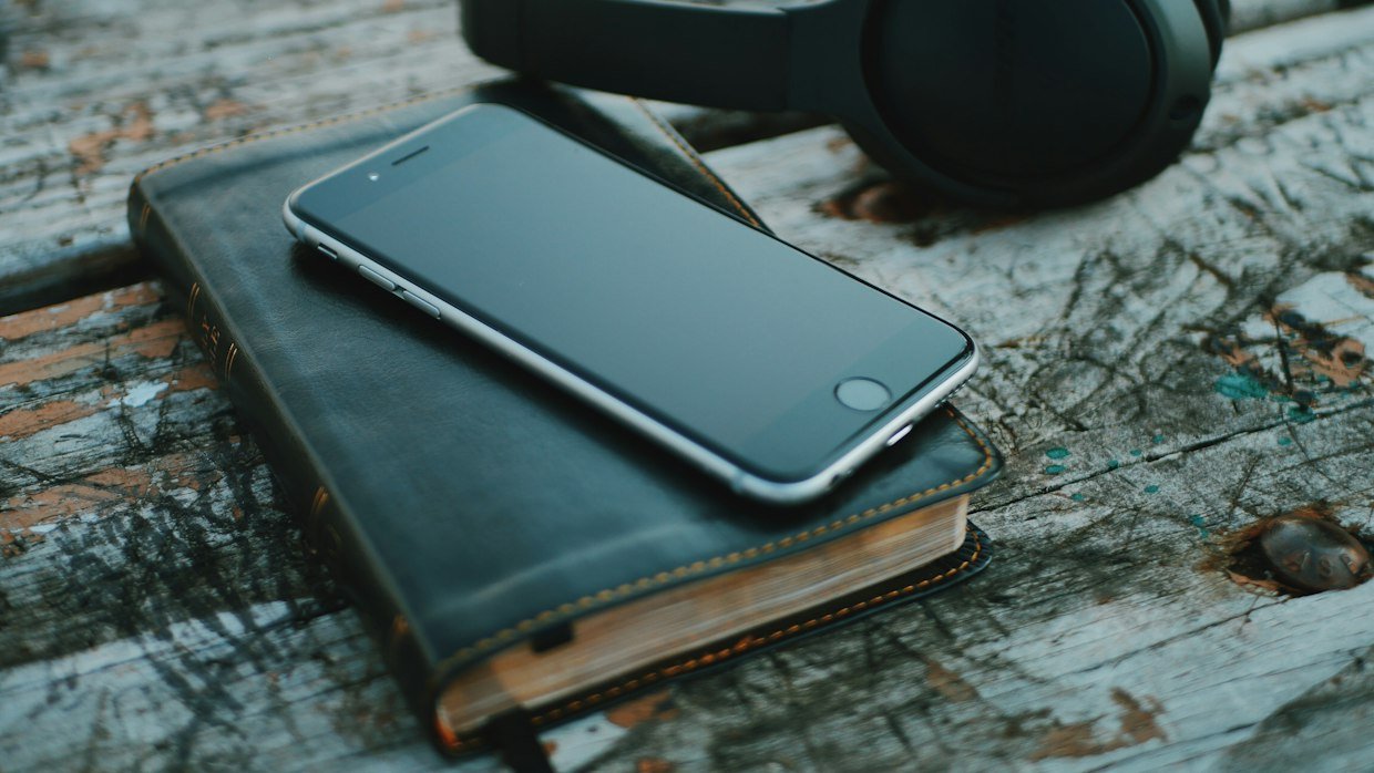 Headphones on a notebook, for testing whether an assistant heard the spoken words.