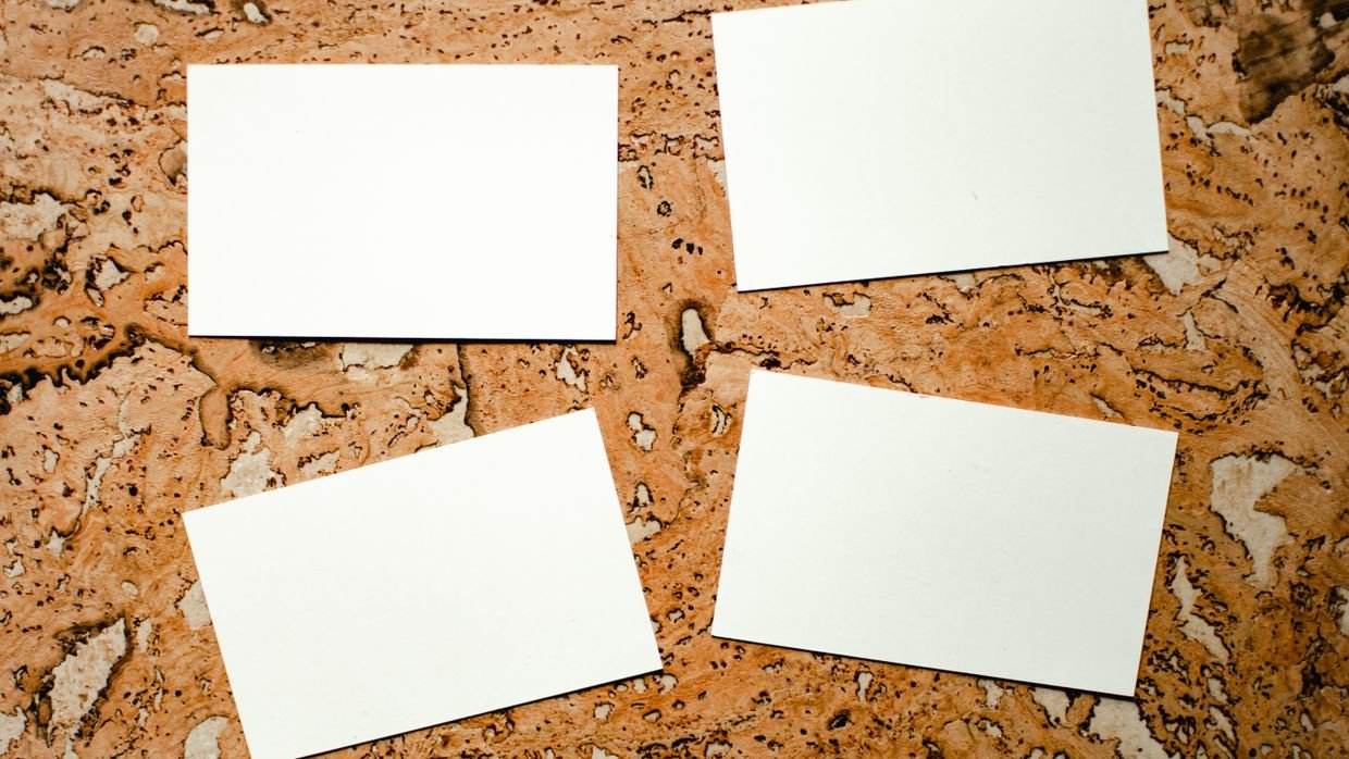 Four blank name cards placed on a table.