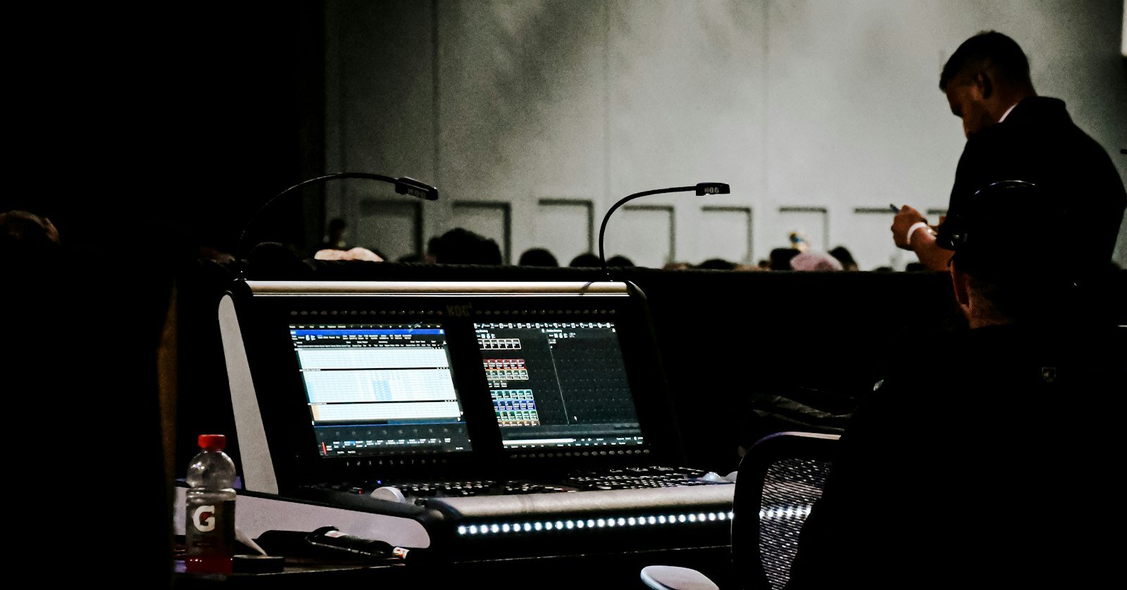 A long table set with several microphones.