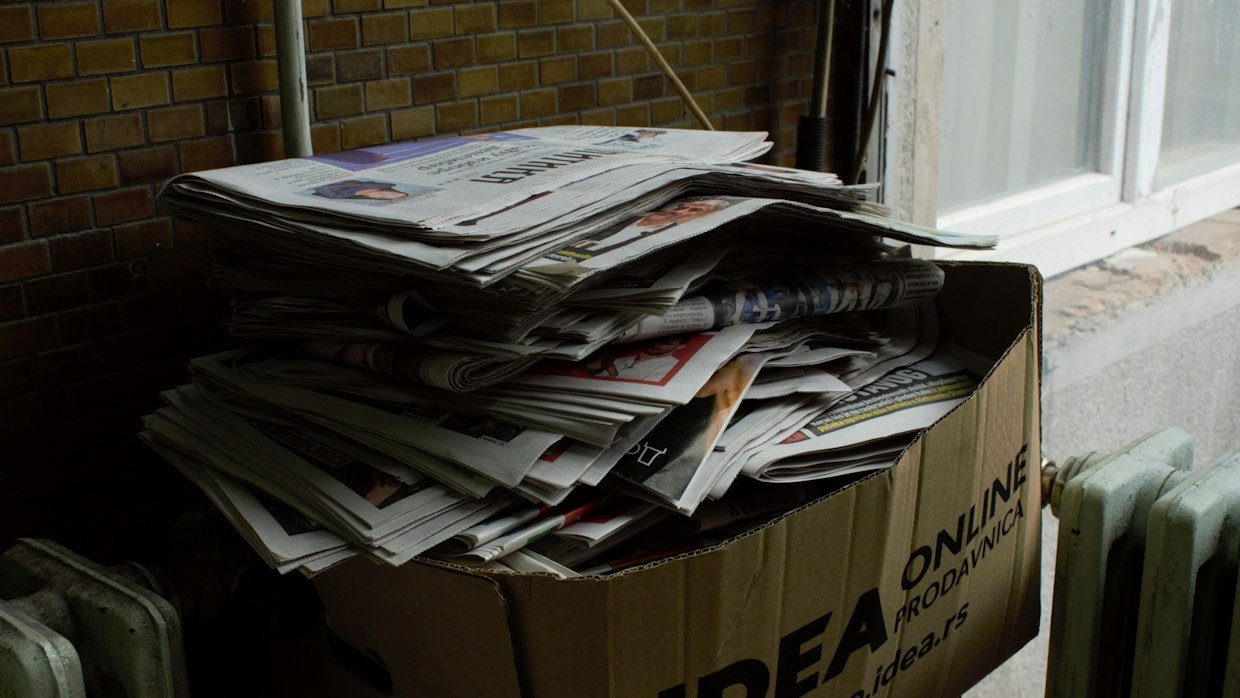 An overflowing paper inbox tray.