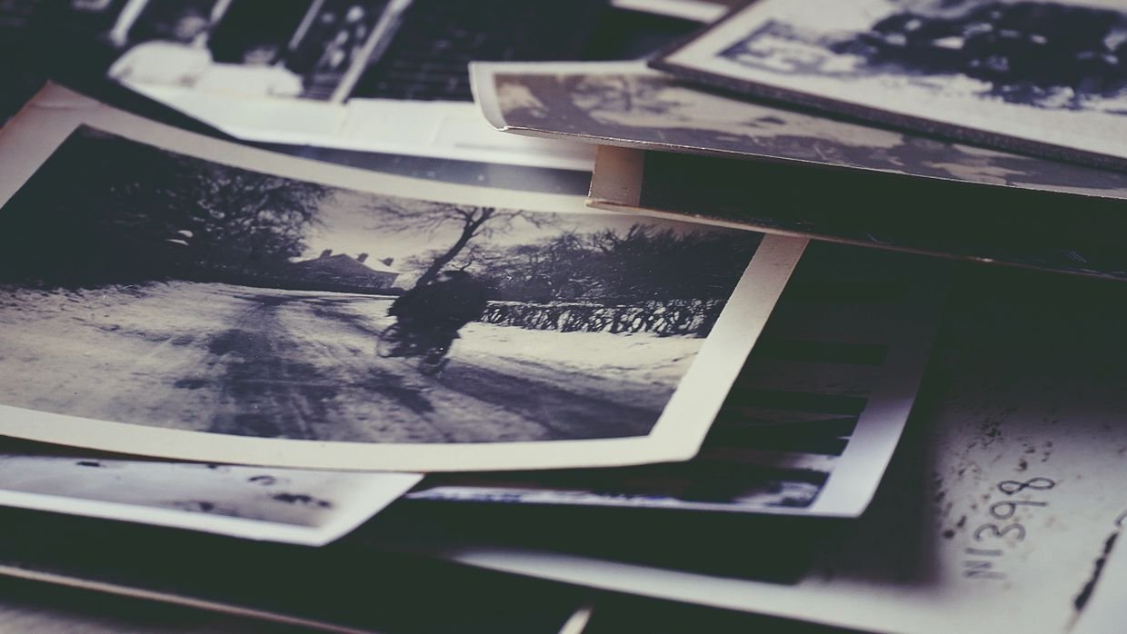 A mixed pile of old photographs.