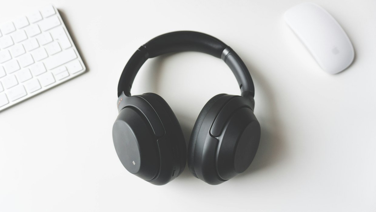 A pair of headphones resting on a desk.