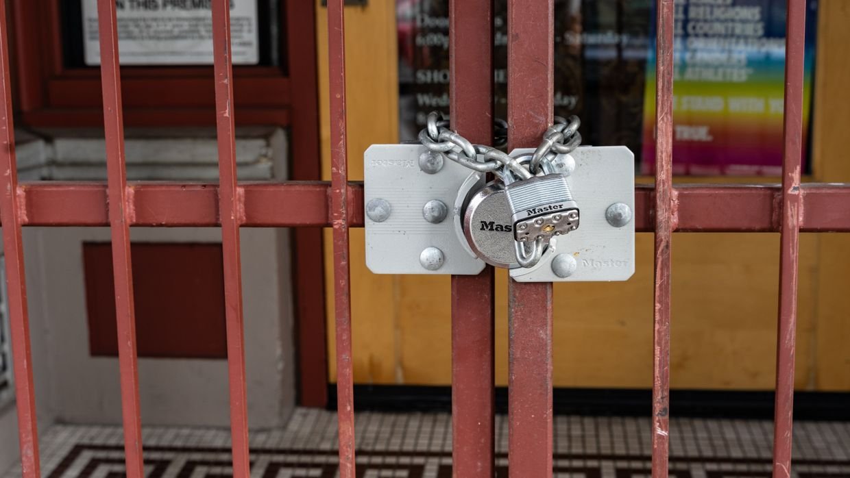 A chain and padlock securing a gate.