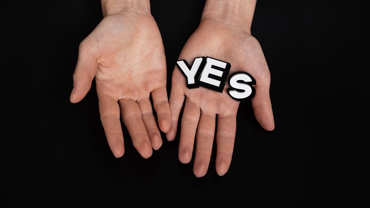 Open hands held palms upward.
