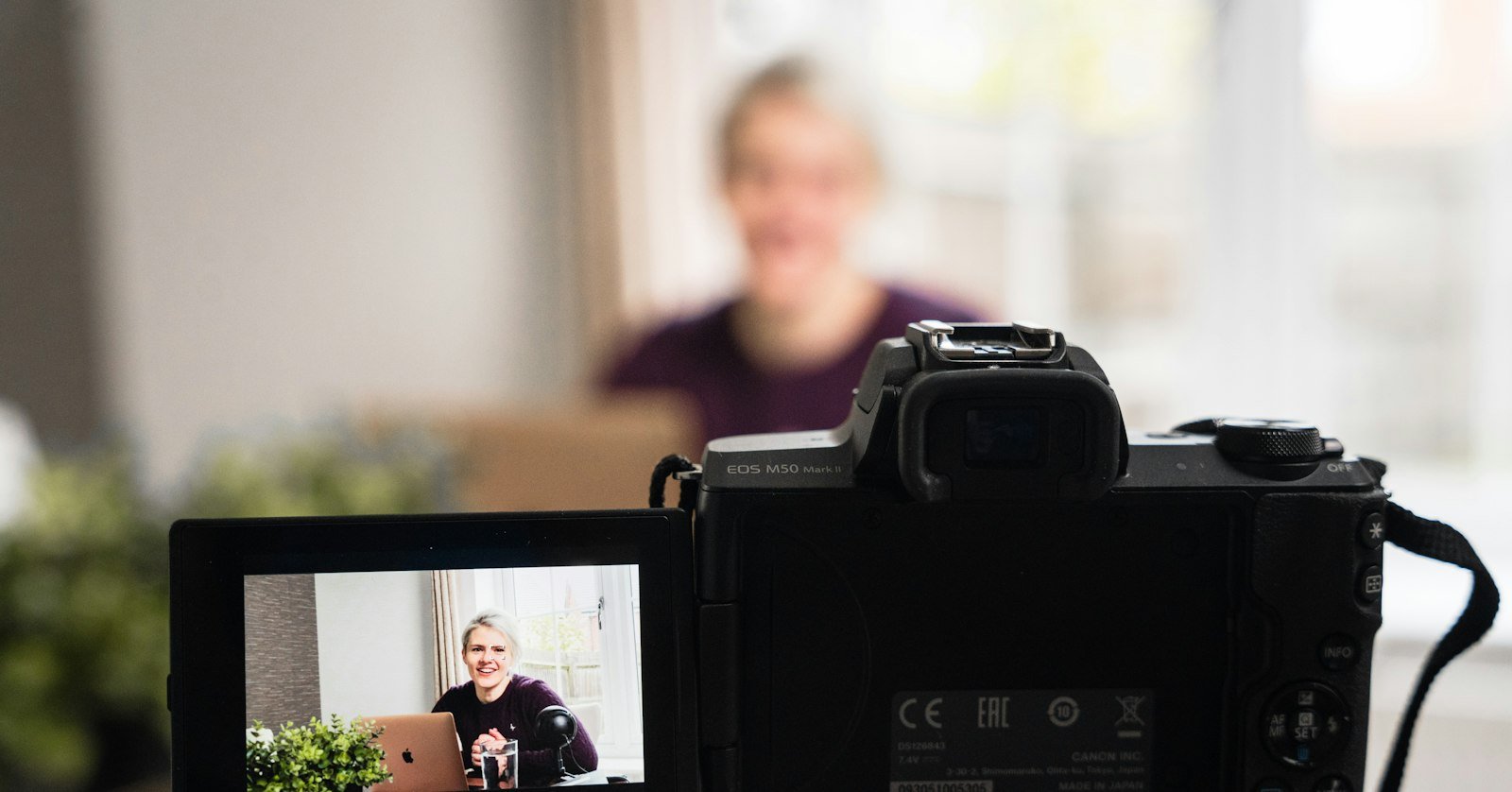 A reviewer filming a product on a desk, for summarizing the verdicts in YouTube review videos.