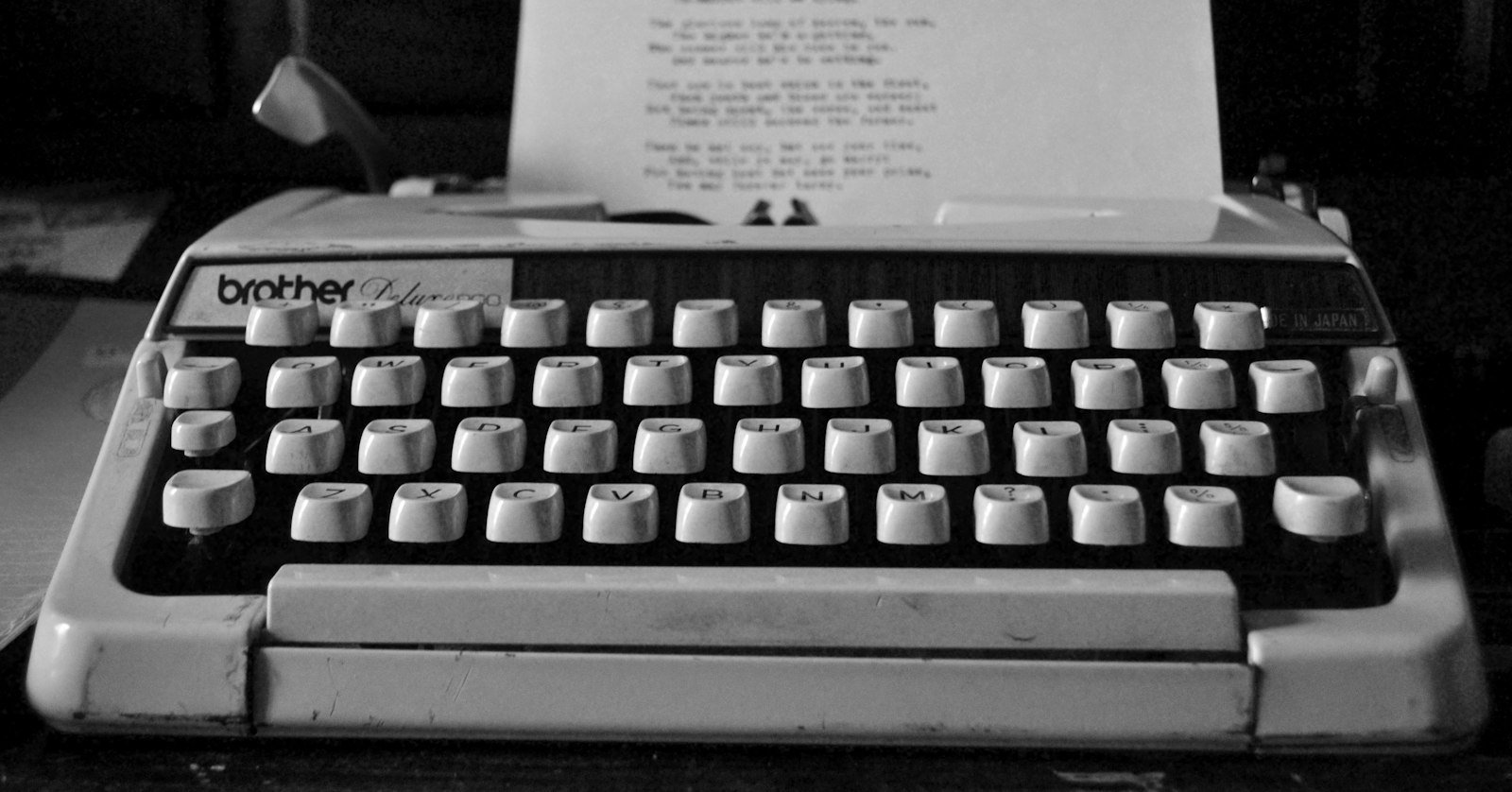 A typewriter next to a video camera.