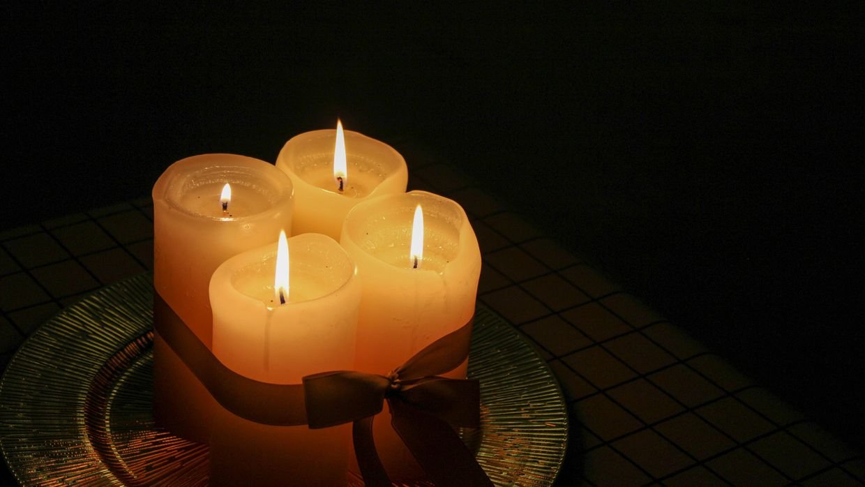 A candle burning in a dim interior.