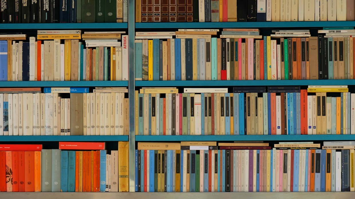 Numbered books lined up on a shelf.