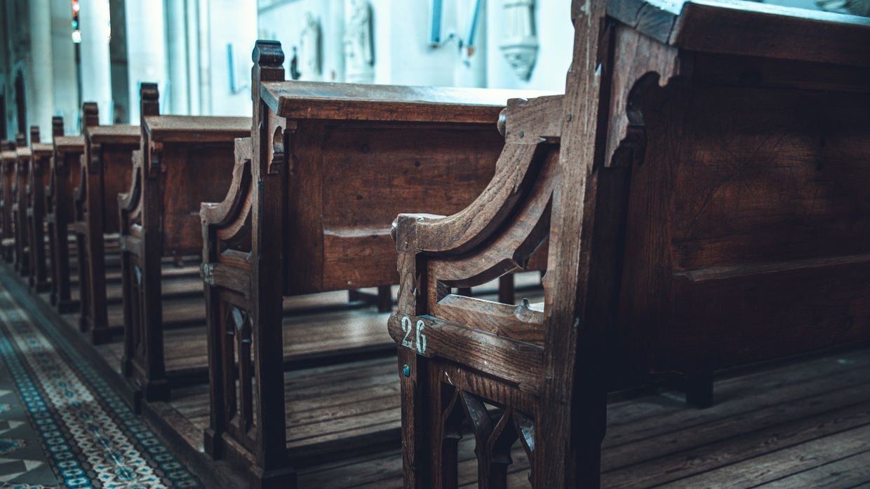Rows of empty wooden pews.