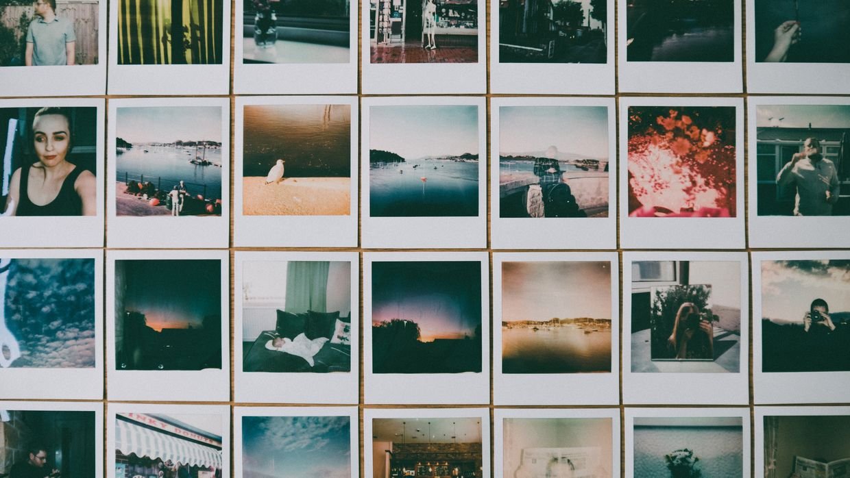 A grid of small photo prints laid on a table.