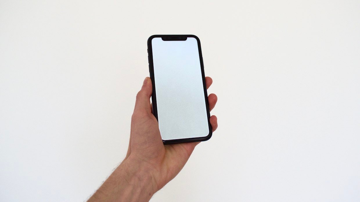 A thumb scrolling on a phone screen.