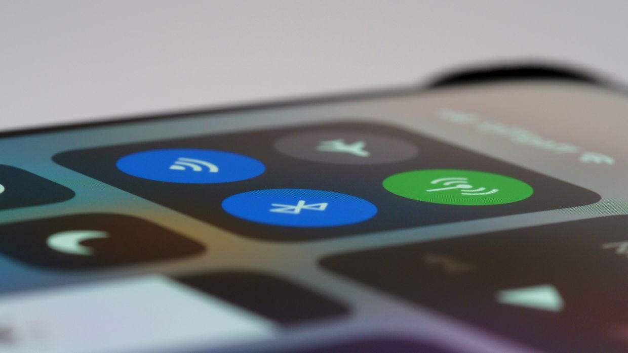 A hand holding a smartphone, for sharing a YouTube video into Snipd.