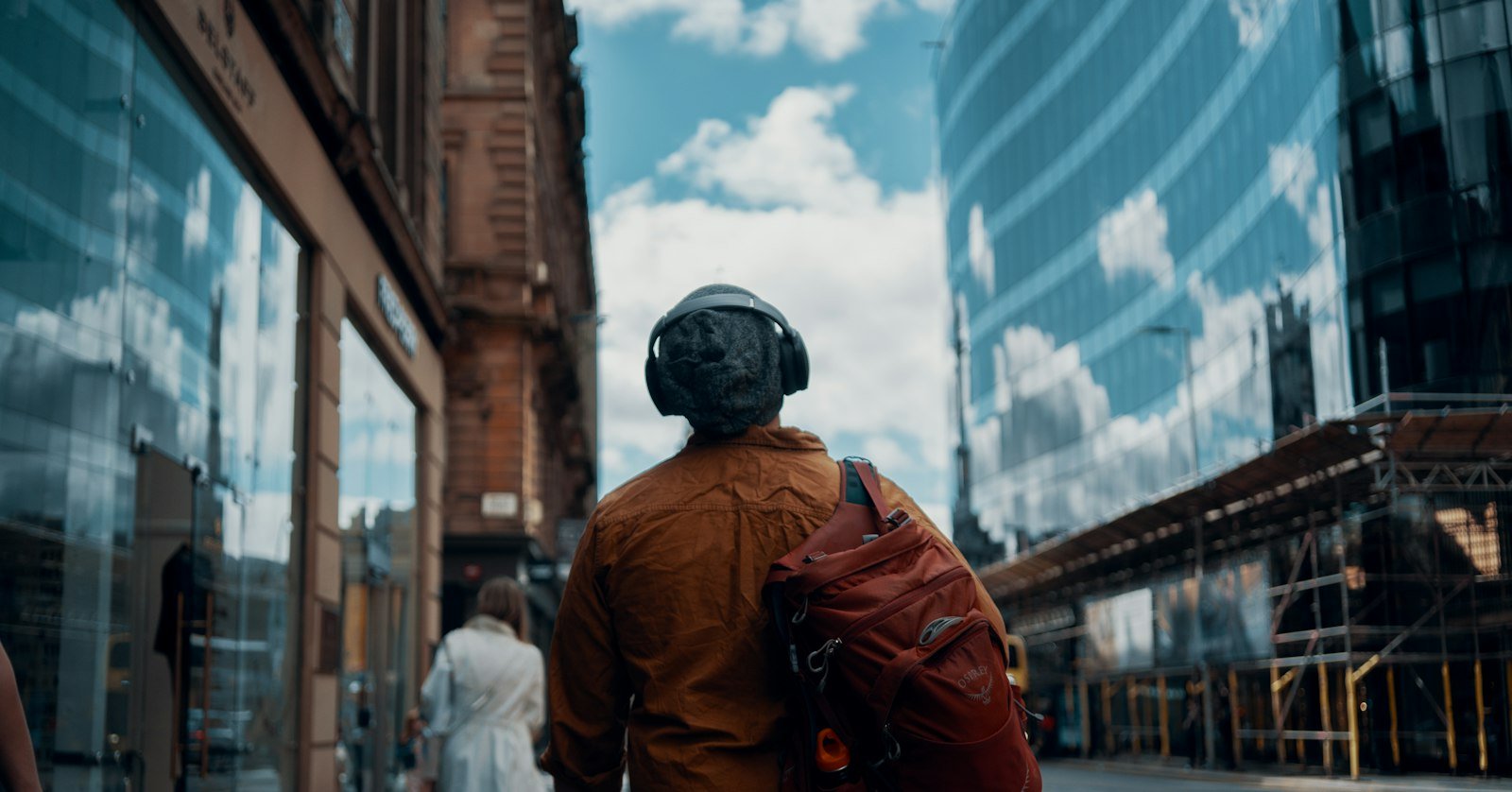 A person walking with headphones on, for listening to YouTube videos as audio in Snipd.