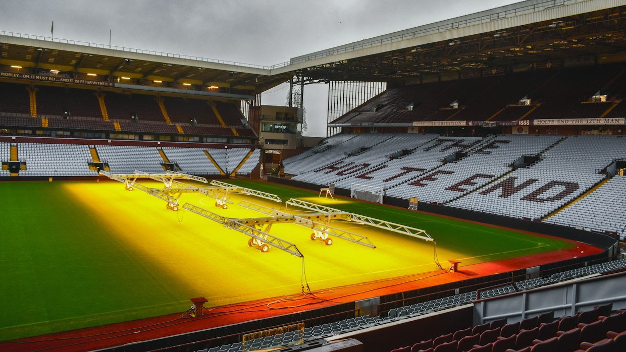 Floodlights above an empty pitch.