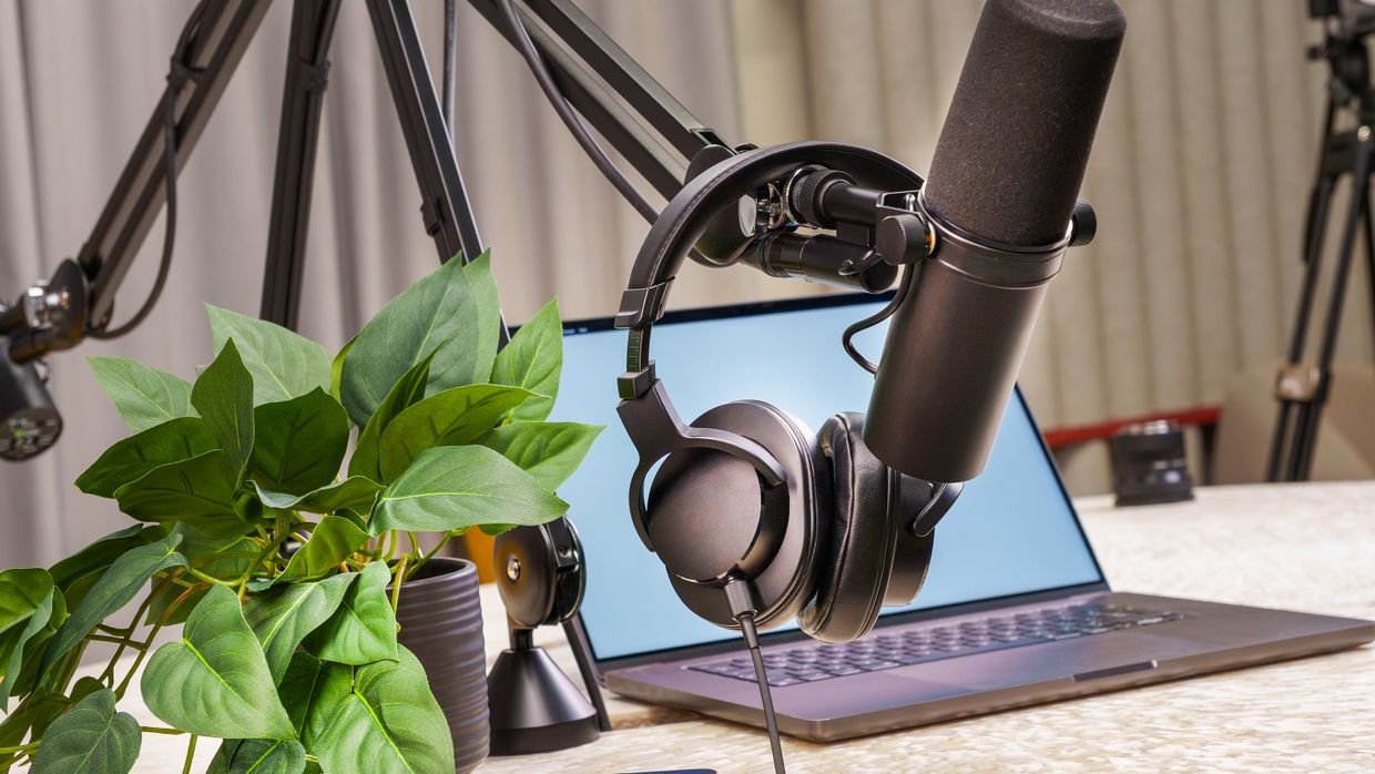 A broadcast desk with headphones resting on it.