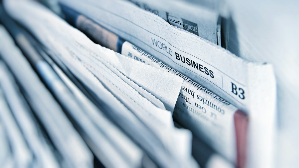 A stack of sports newspapers.