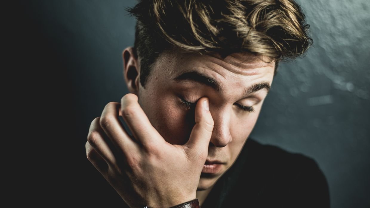 Someone pausing to think, eyes closed.
