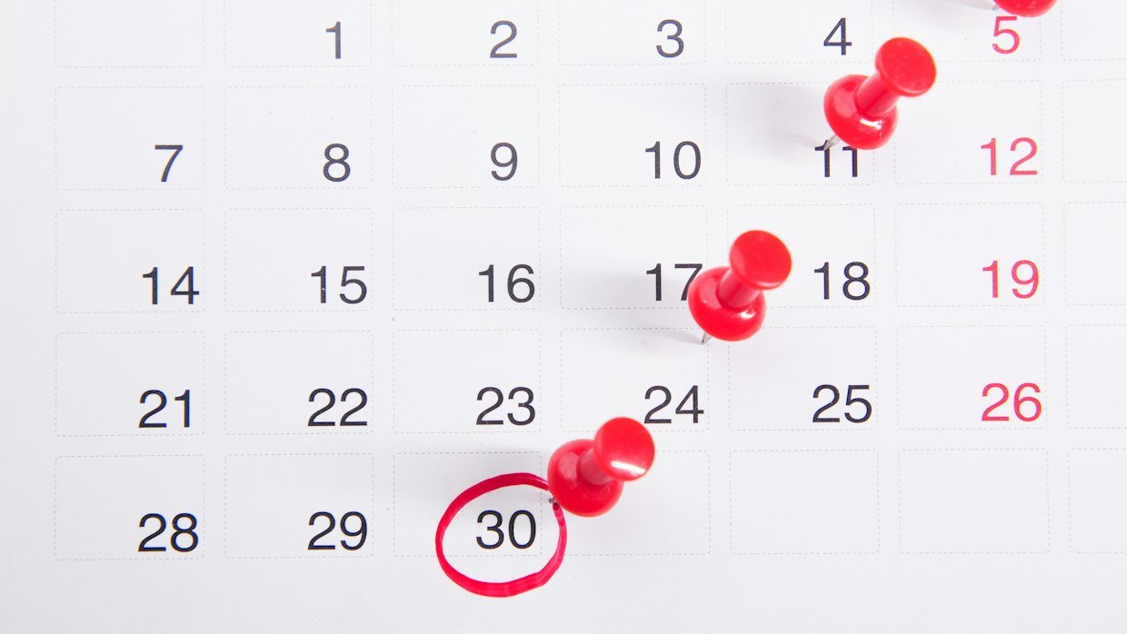A wall calendar with dates circled in pen.