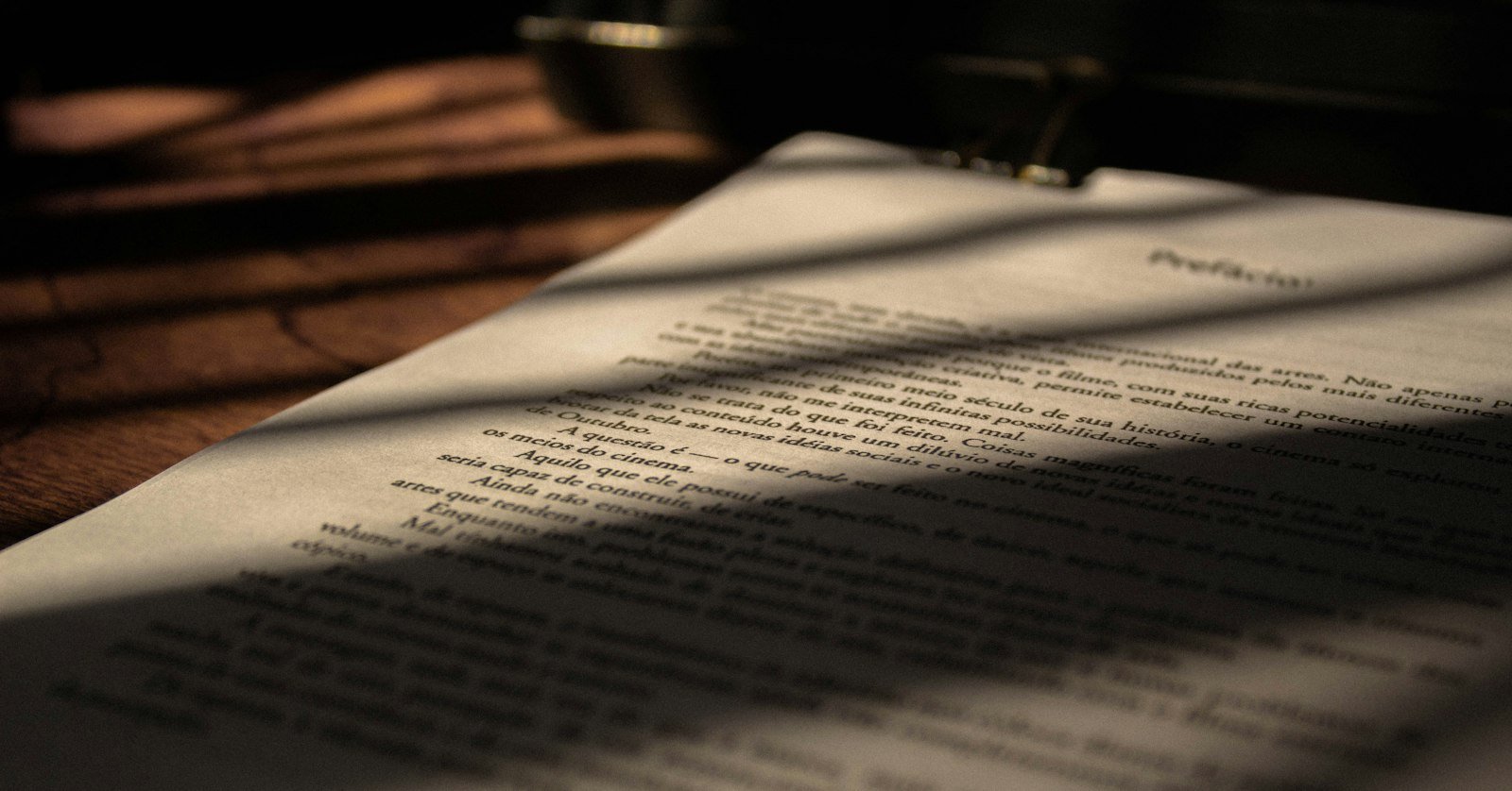 A thick document lying beside a short note.