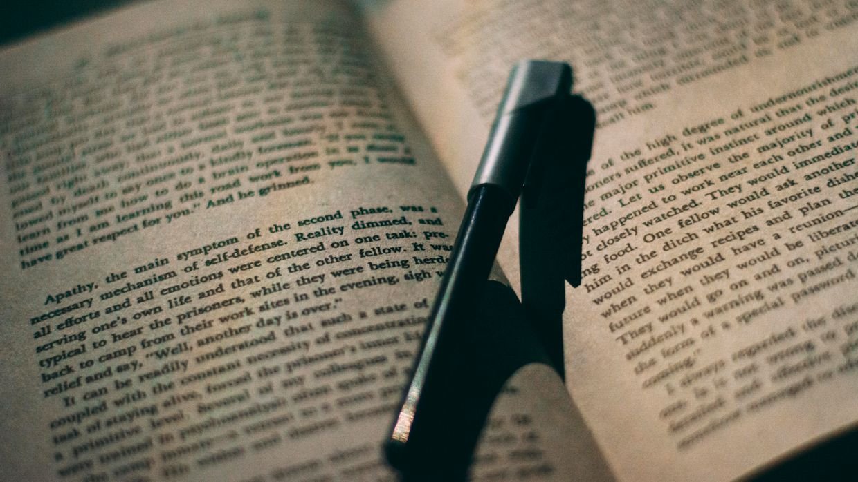 A red pen marking corrections on a page.