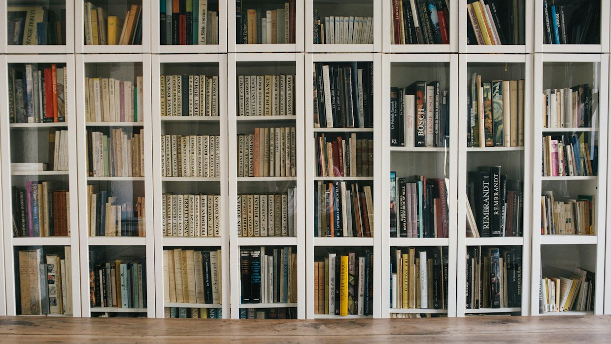 An open book on a library table.