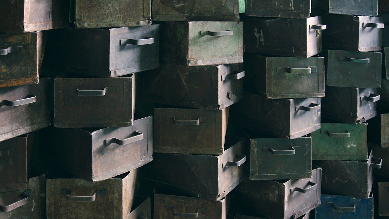 A wall of many small labelled drawers.