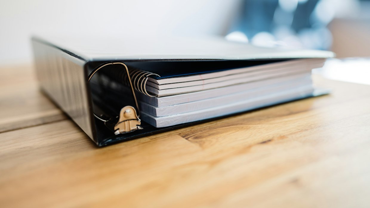 Tabbed dividers separating sections in a binder.