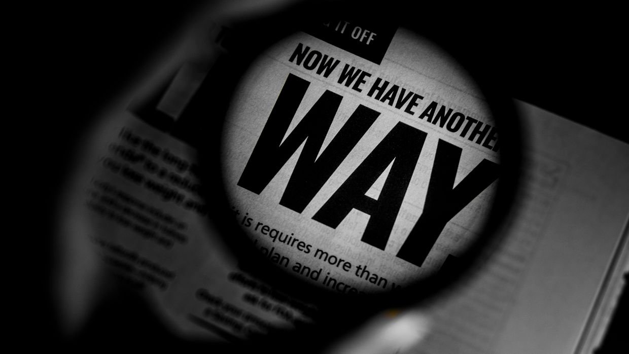 A magnifying glass over a line of printed text.