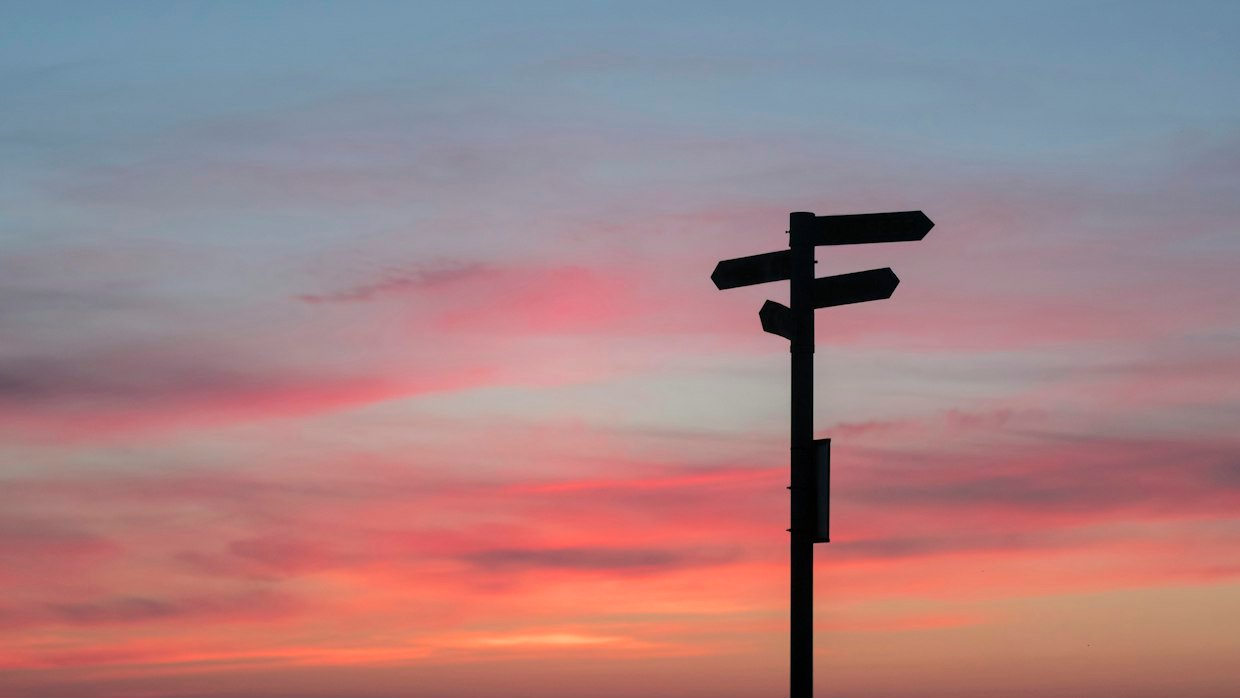 A signpost pointing in three directions.