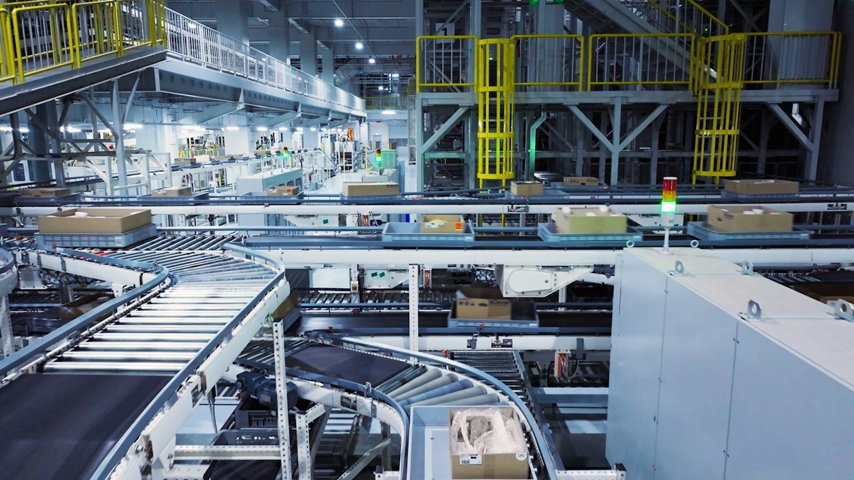An empty conveyor belt running through a factory.
