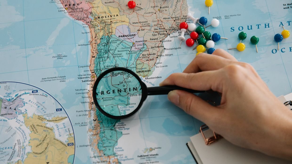 A world map with pins marking several countries.
