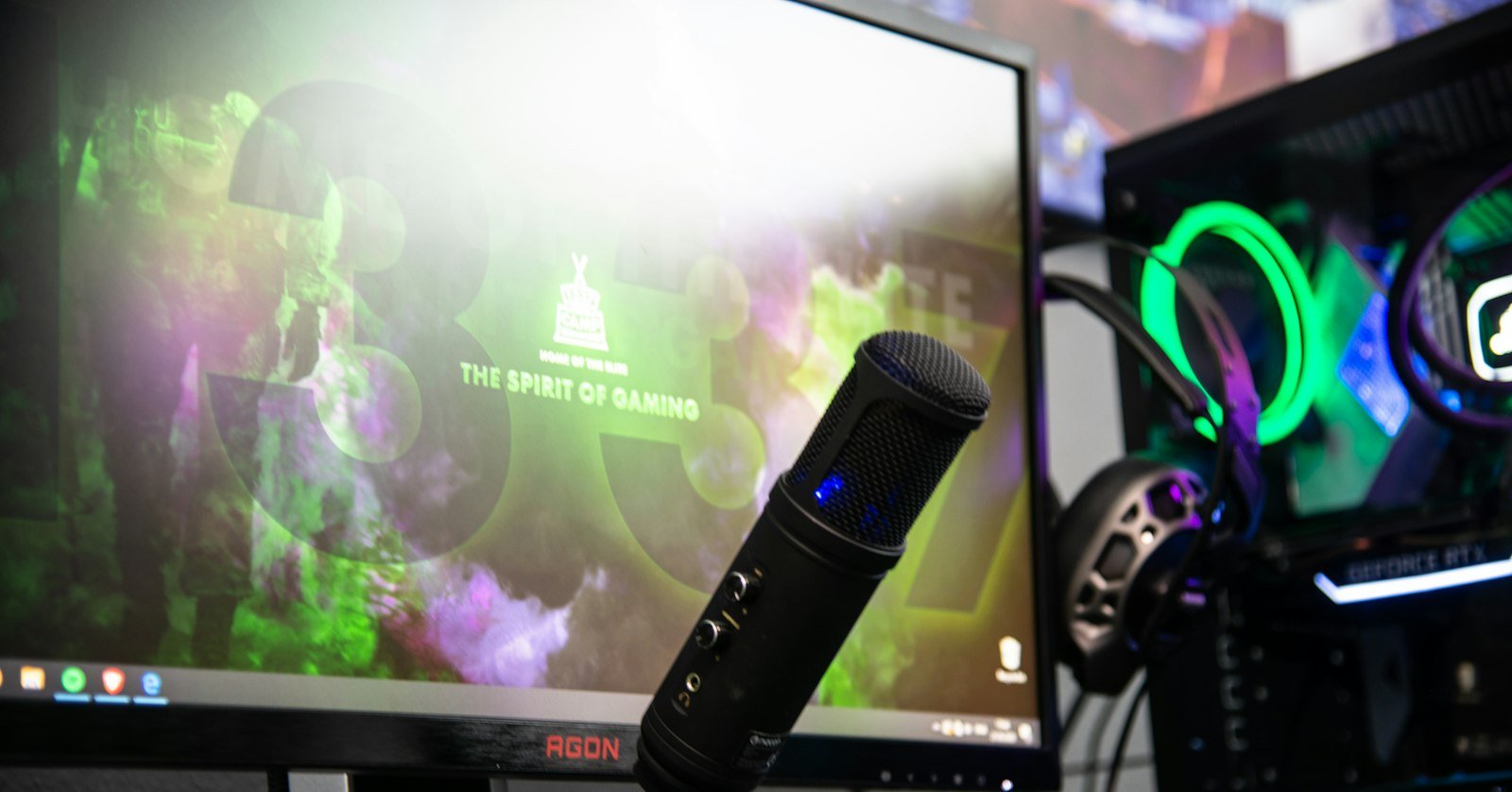 A streaming desk with a microphone and lights.