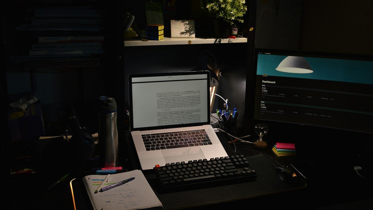 A switched-off monitor in a dark room.