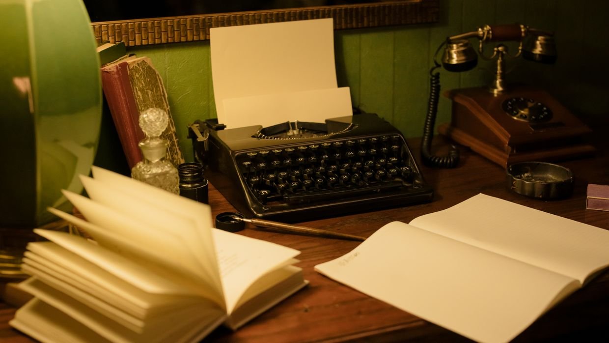 A worn notebook reopened on a desk.