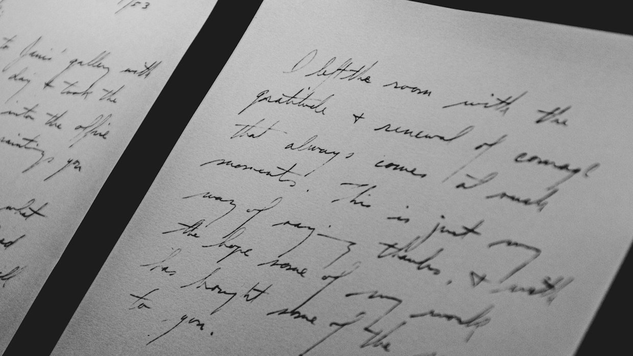 A typed page lying beside a handwritten one.