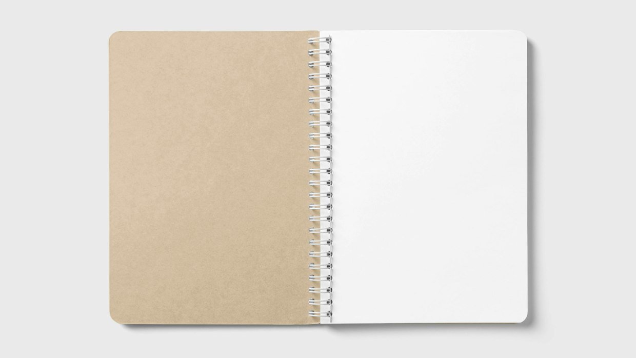 Two notebooks open side by side on a desk.