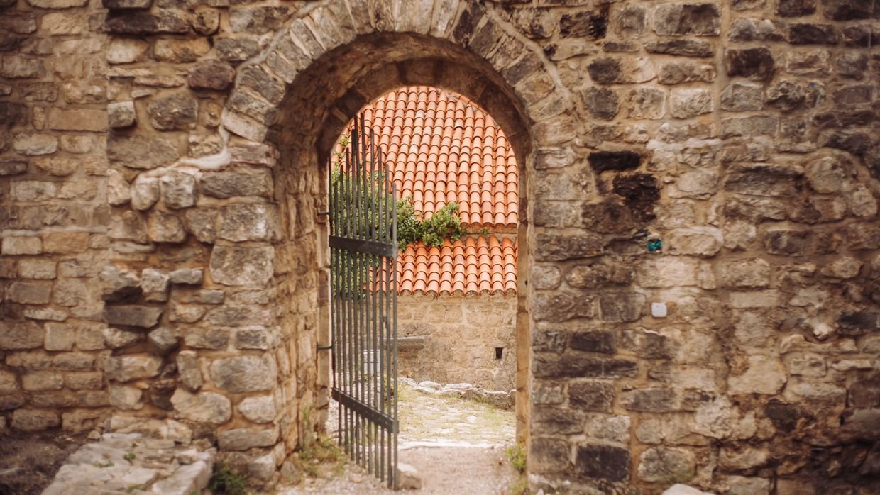 An open gate set into a stone wall.