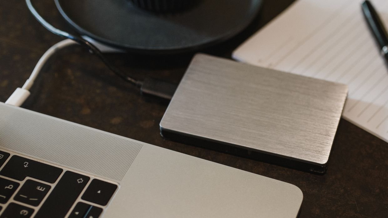 An external drive plugged into a laptop.