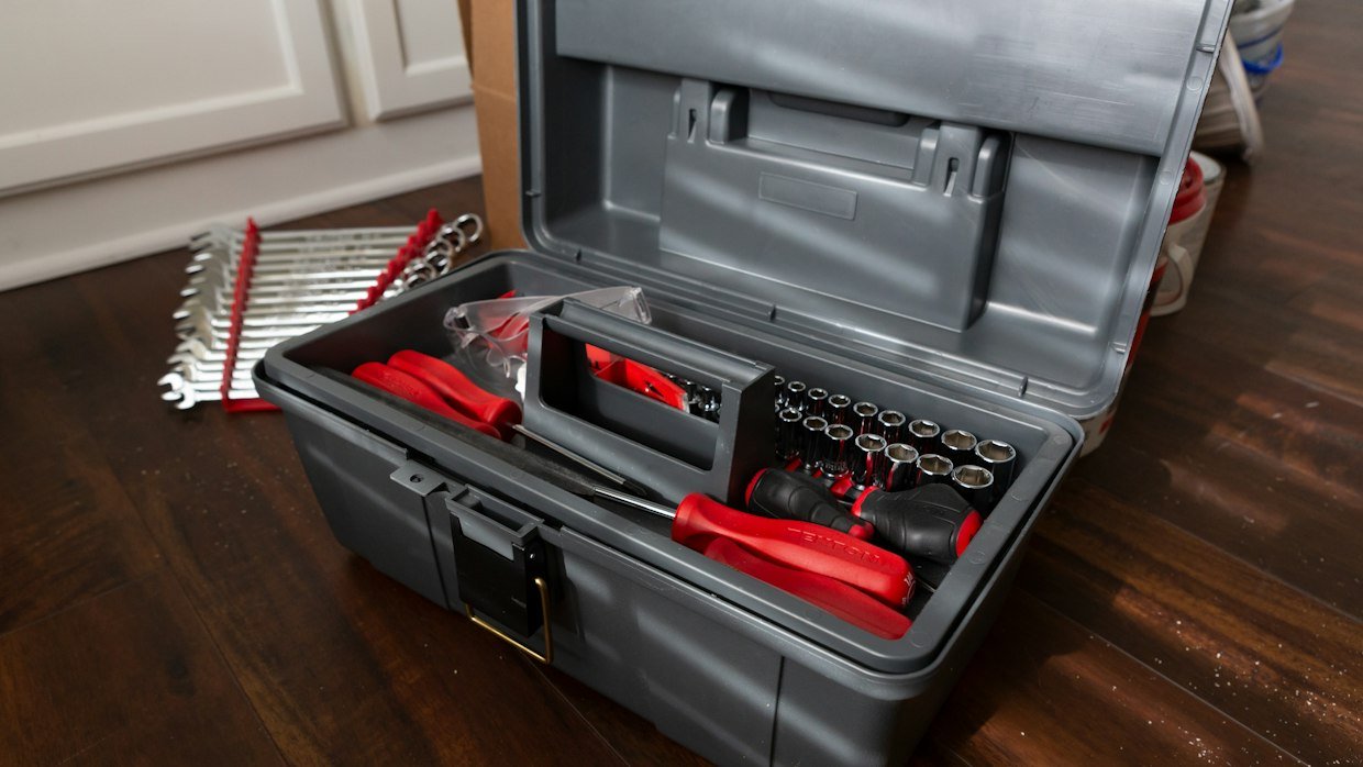 An open toolbox with assorted tools.