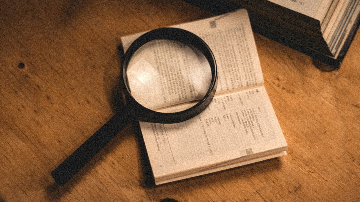 A magnifier held over handwritten notes.